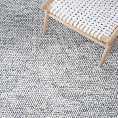 Close view of pebble texture flatweave pure wool rug with natural woven surface