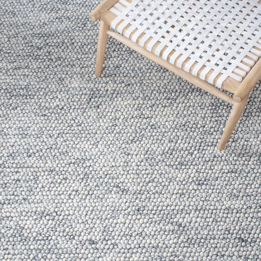 Close view of pebble texture flatweave pure wool rug with natural woven surface