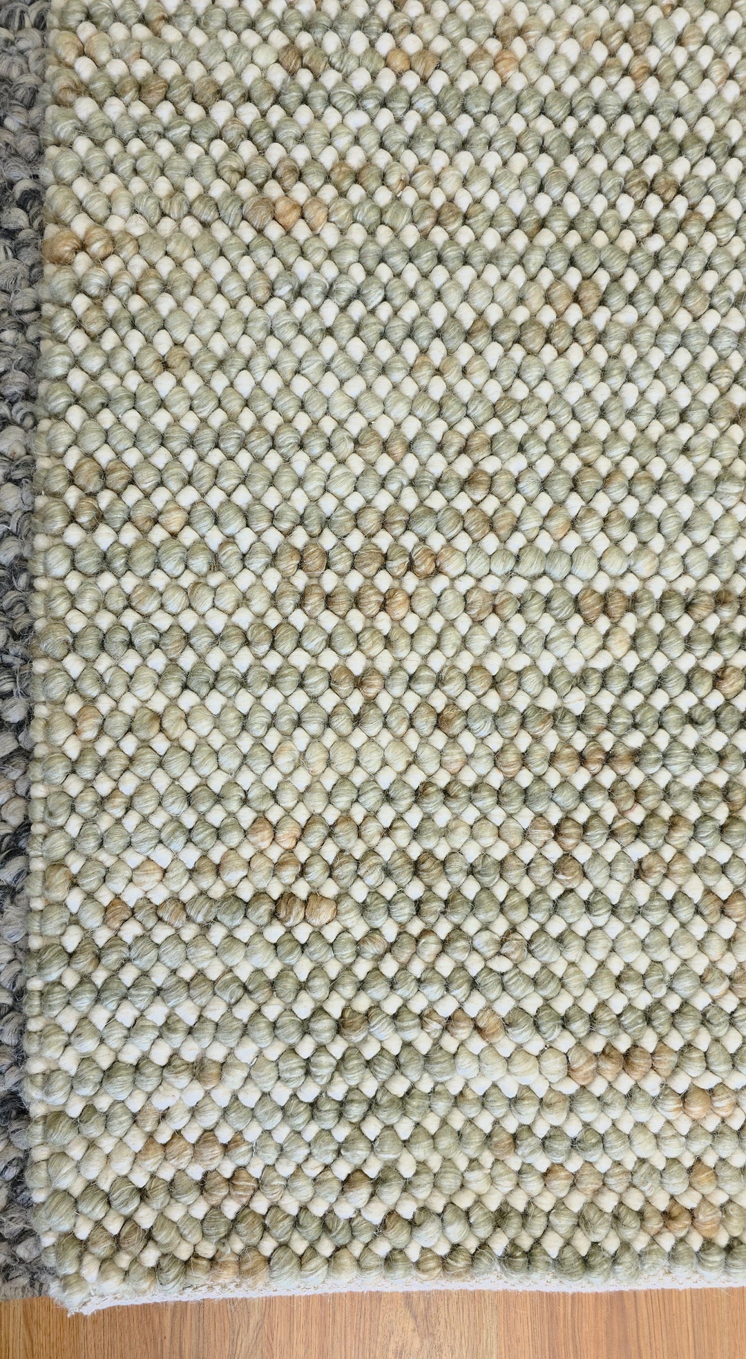 Close-up of Pebbles Sage Green round flatweave rug texture showing detailed weave and natural sage green tones.