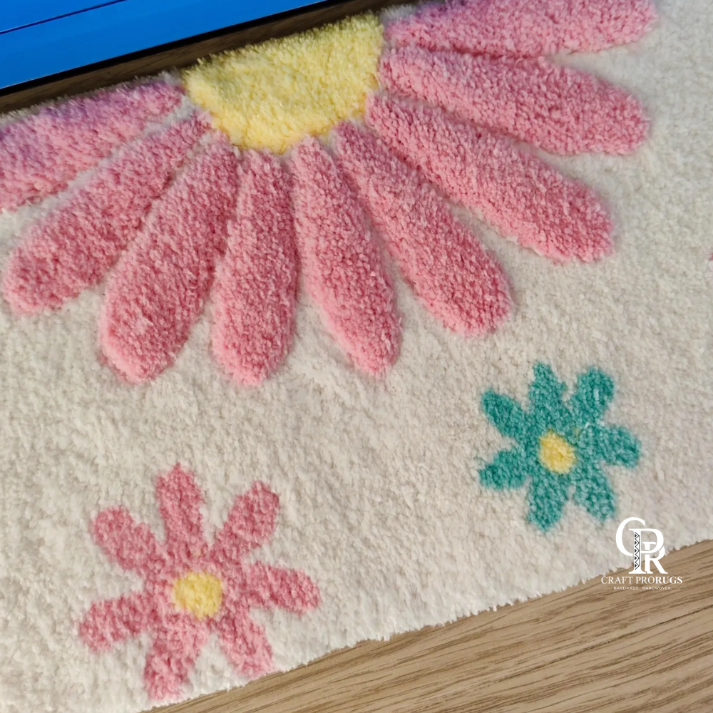 Close‑up of tufted yarn texture on pink floral desk mat