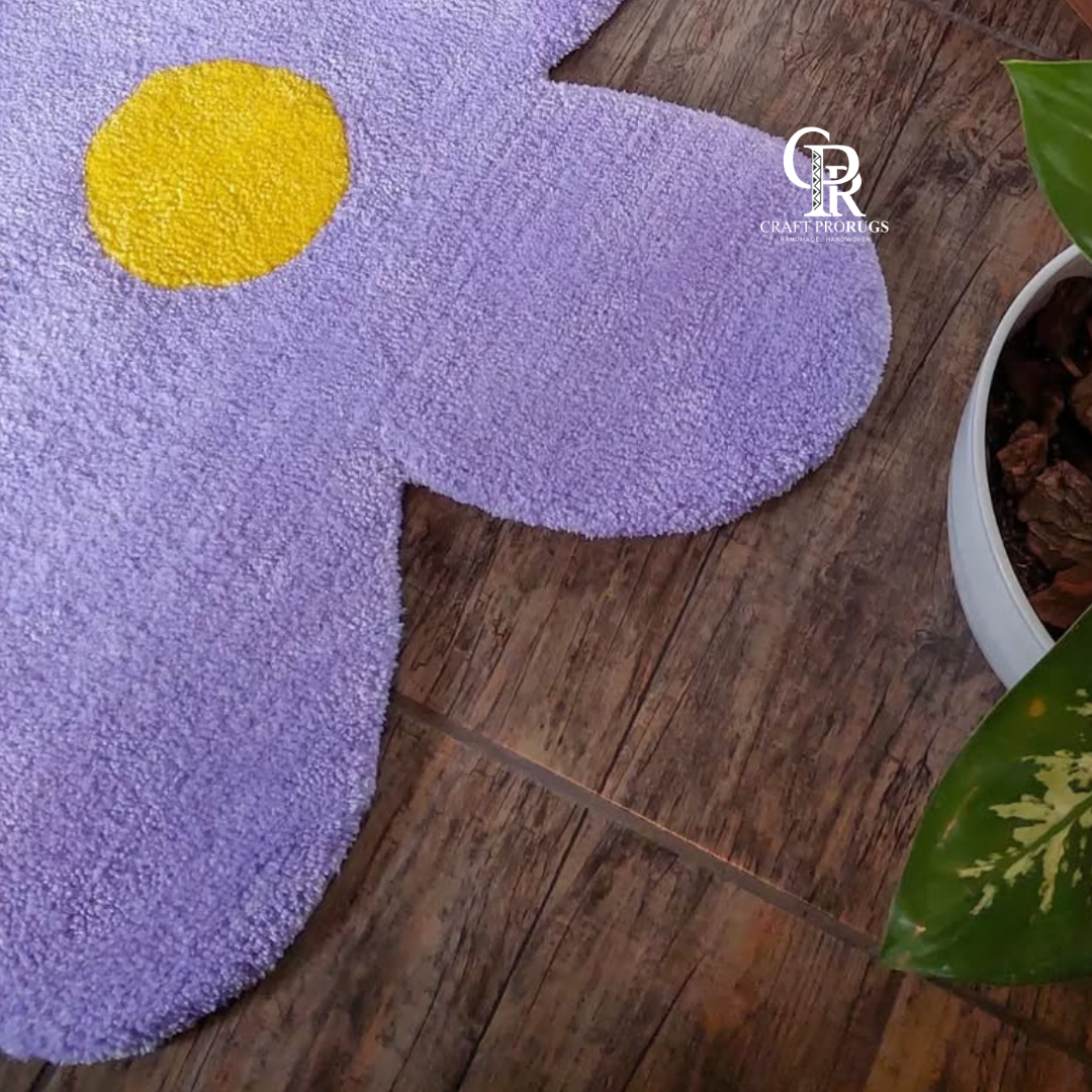 side angle of purple flower shaped hand-tufted rug showing thickness, tufted petals, and shape