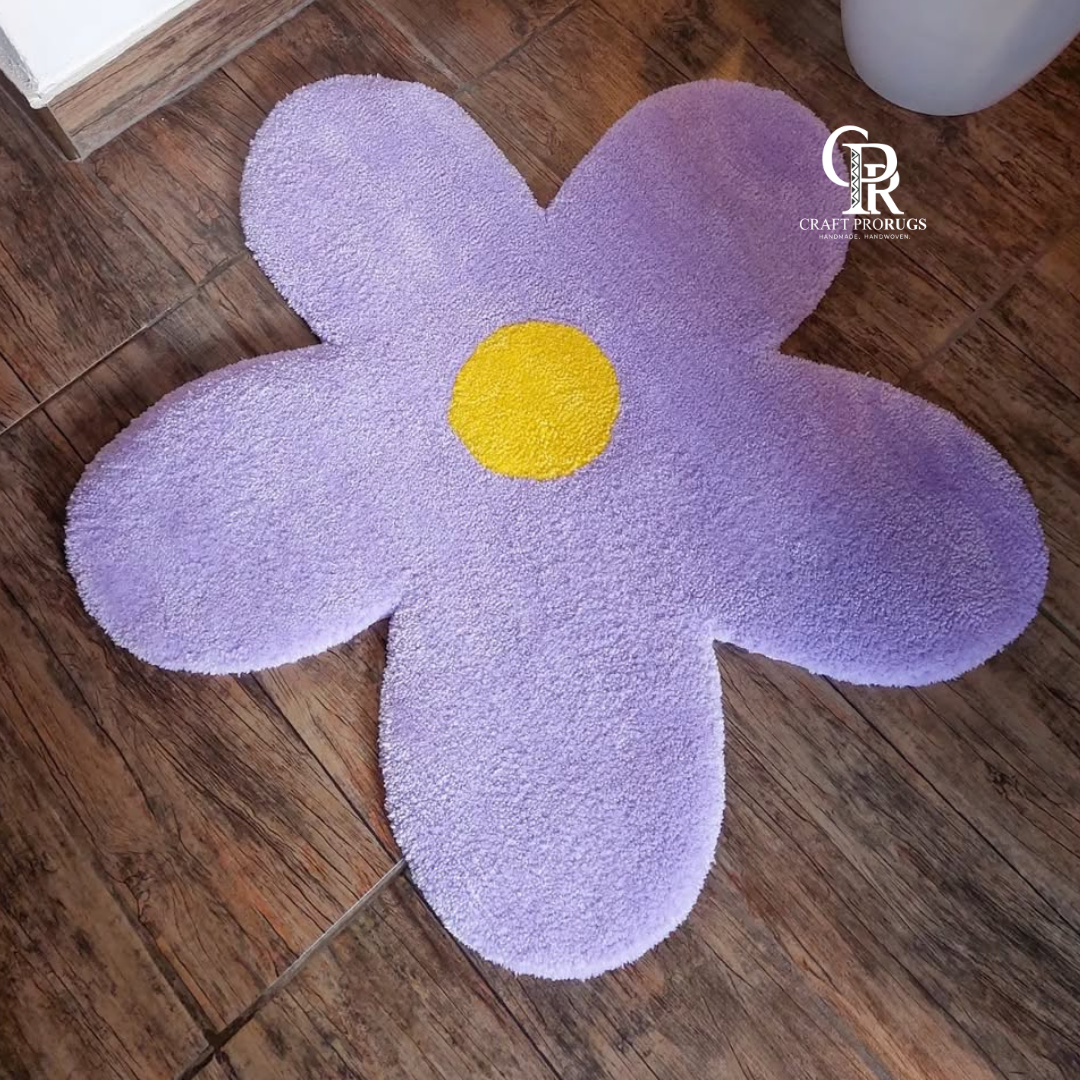 top view of purple flower shaped hand-tufted rug on floor showing full flower pattern and color details