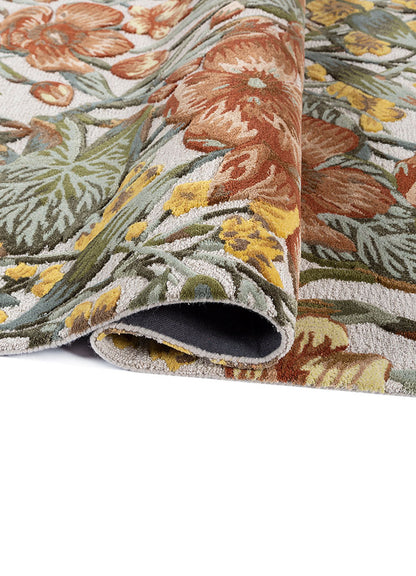 Rolled detail of Regal Botanique hand tufted wool rug showing soft pile flexible structure and rich botanical motifs.