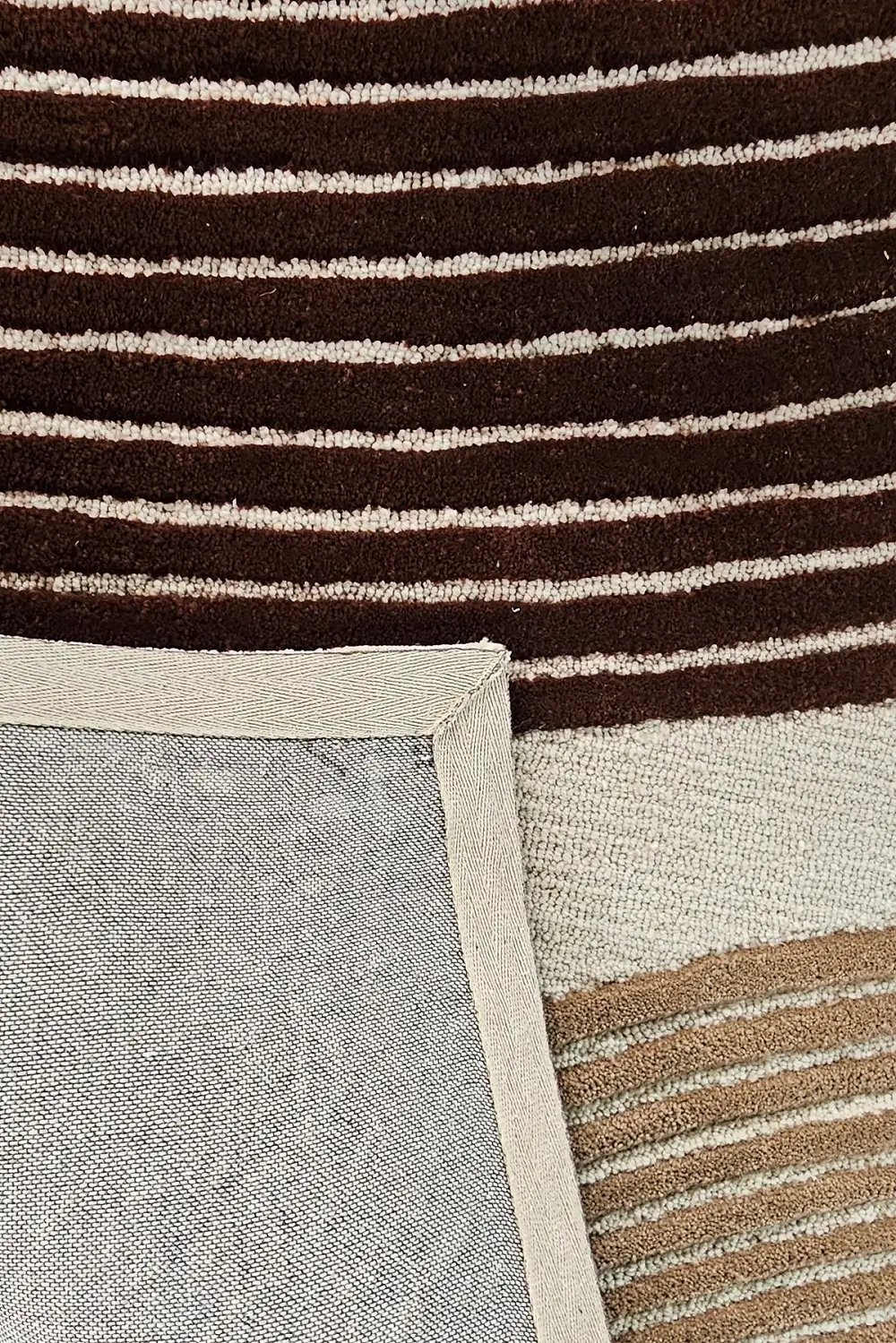 Back edge detail of Sienna Wave hand tufted wool rug showing clean finishing and durable wool construction.