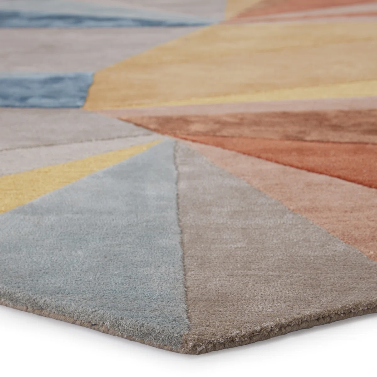 corner of stanford geometric rug highlighting hand-tufted craftsmanship and color details.