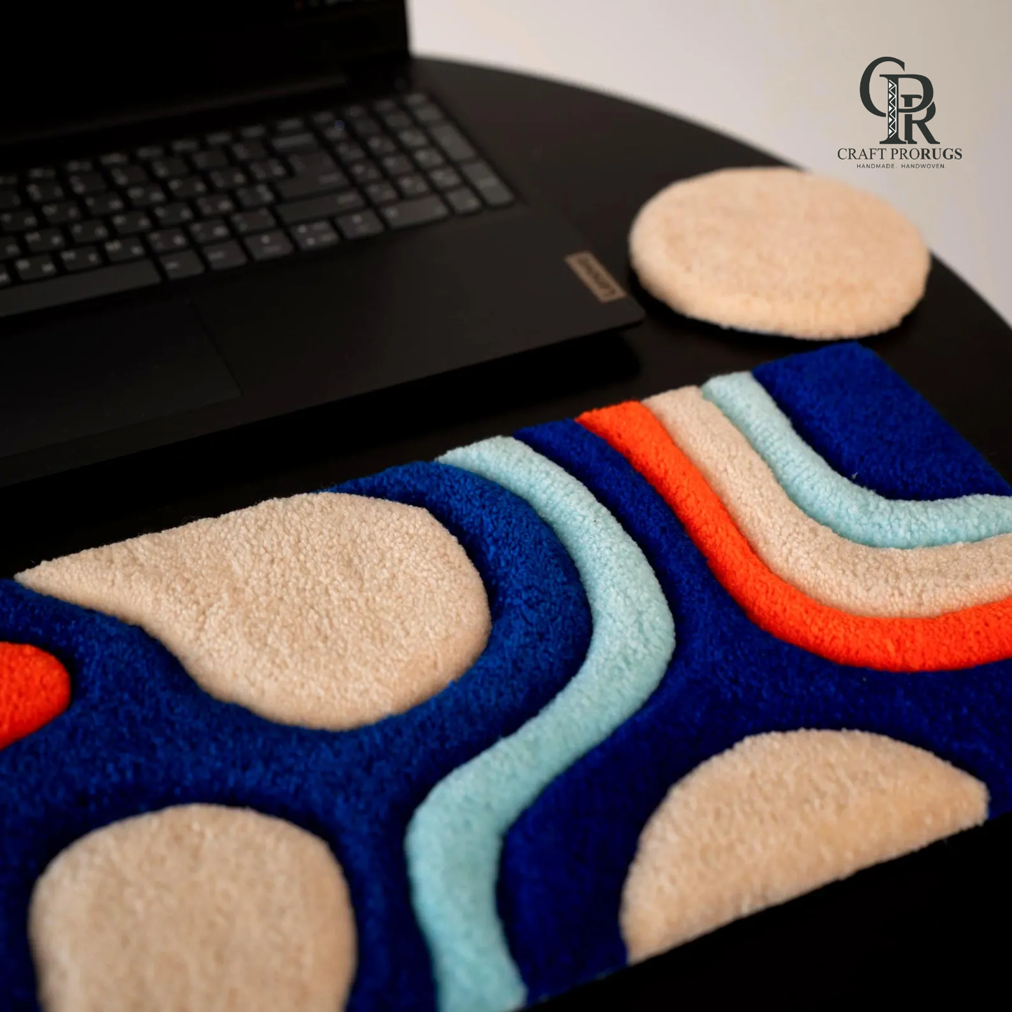 Side angle view of Wave Flow Desk Rug highlighting ergonomic wrist rest shape and vibrant color flow