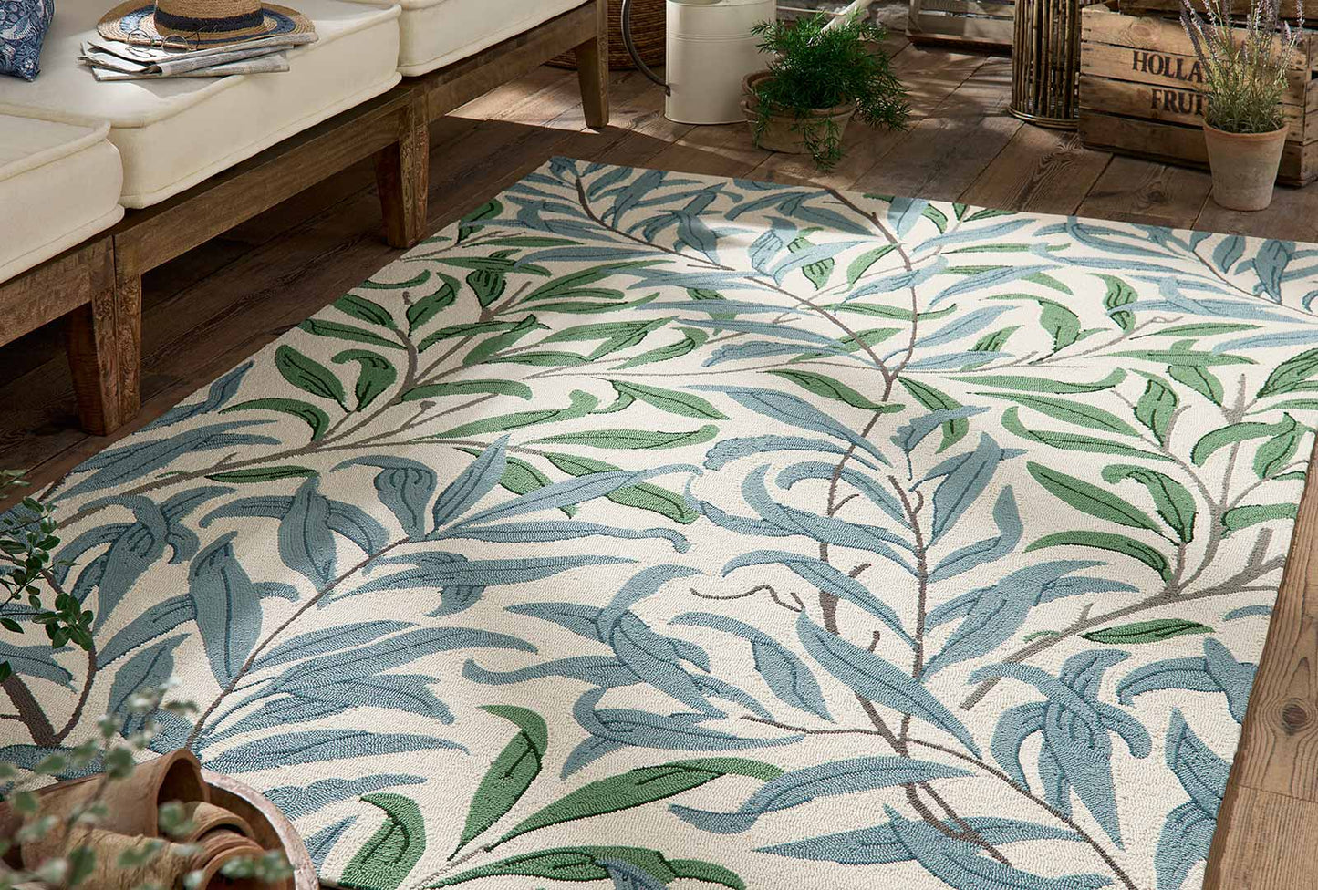 Willow Leafy Arbour hand tufted wool rug placed under seating highlighting botanical leaf pattern and natural color palette.