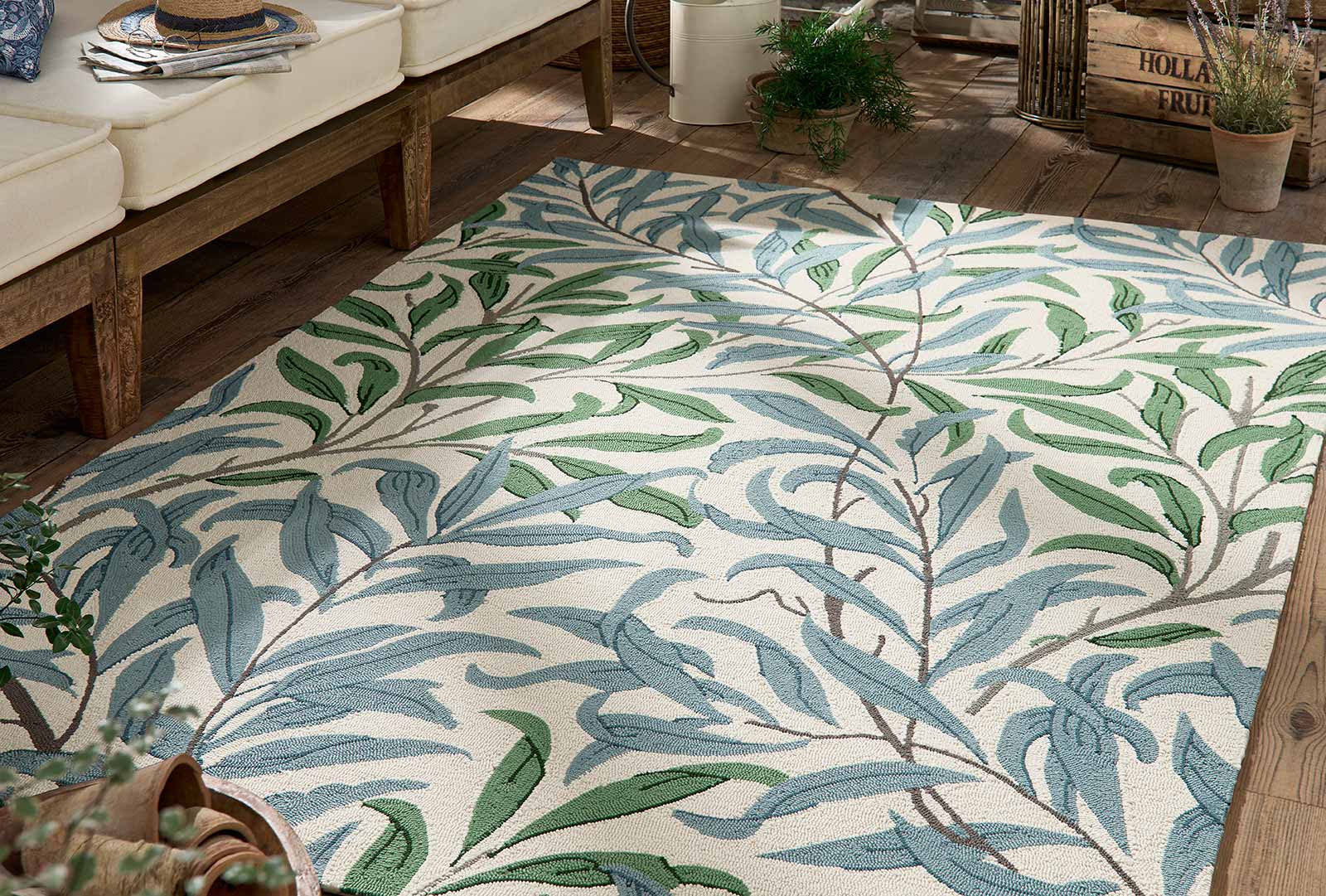 Willow Leafy Arbour hand tufted wool rug placed under seating highlighting botanical leaf pattern and natural color palette.