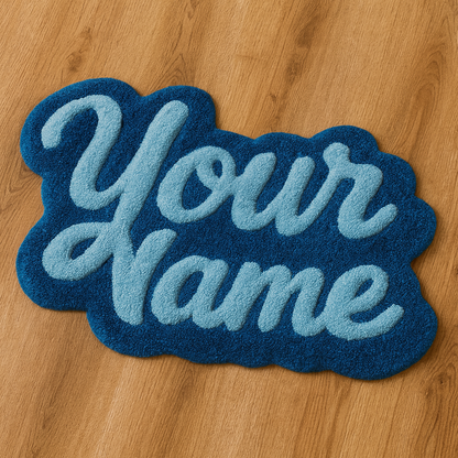 Blue hand-tufted rug with ‘Your Name’ text on a wooden floor