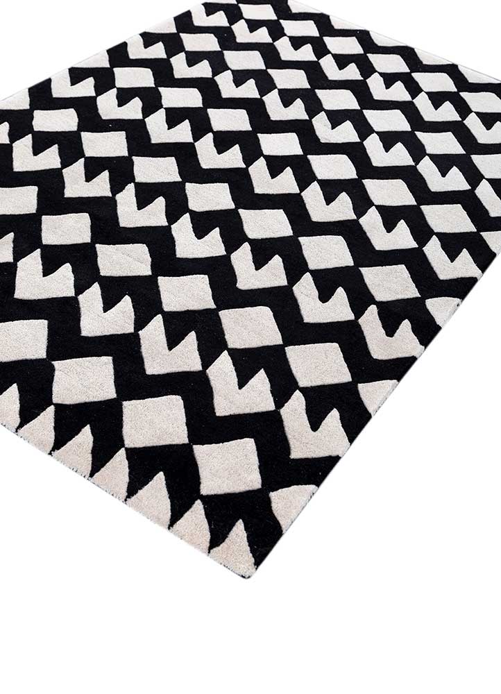 Angled view of zigzag monochrome wool rug highlighting texture and hand-tufted craftsmanship.