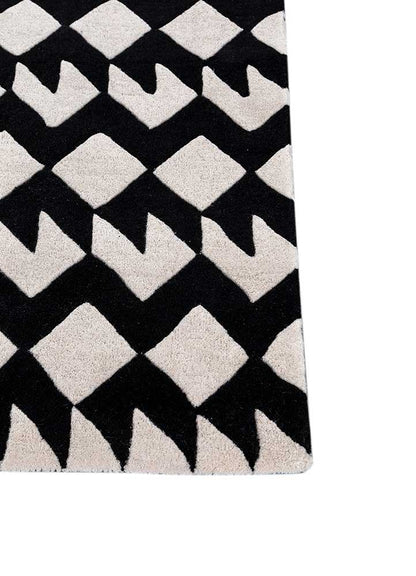 Corner of zigzag monochrome wool rug showing geometric design and soft wool texture